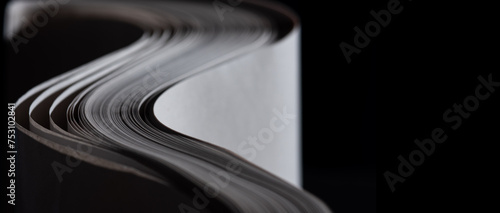 Quadro su tela sheets white paper edge flow wave shape on black copy space empty background