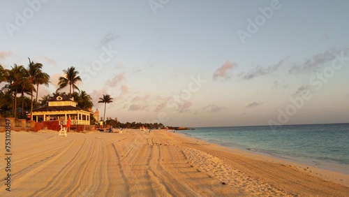 Photos Golden Hour at Serene Tropical Beach with Thatched Bar and Palm Trees