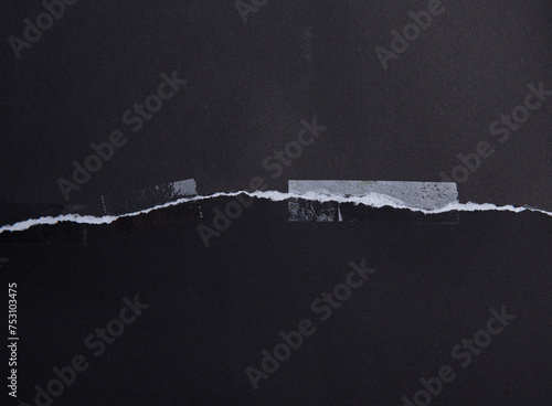 Torn black paper with transparent adhesive tape or strips,repair paper