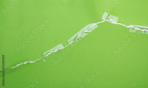 Torn green paper with transparent adhesive tape or strips,repair paper