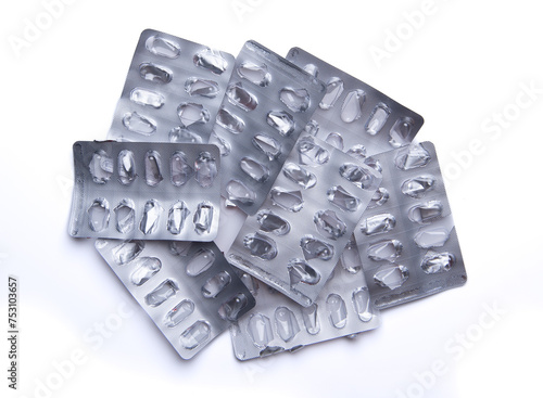 Used empty pill blister pack, discarded silver medicine packs, isolated on white background
