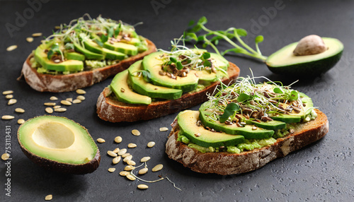 Healthy toasts with avocado slices, seeds and green sprouts. Organic morning meal. Tasty food.