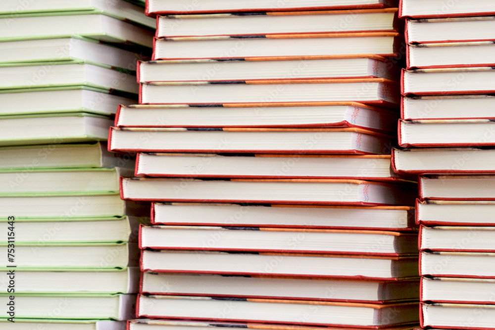 Fototapeta premium Load of knowledge. A large pile of new books in hardcover