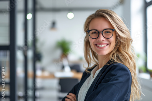 Portrait of smiling young businesswoman with blonde hair, Happy female employee, professional confident woman at modern office, Smiling business woman wallpaper concept, woman wearing blazer in office