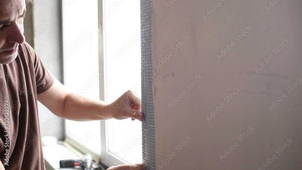 builder or repairman with spatula plasters white wall closeup builder or repairman with spatula plasters white wall closeup