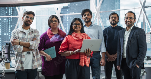 Group of Happy Multiethnic Indian Team of Female and Male Managers, Specialists and Business Professionals Posing for Camera and Smiling. Portrait of a Confident South Asian Team Leader Standing First