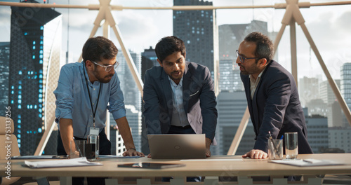 Fotografie Cinematic Footage of a Successful Indian CEO Making a Presentation on a Laptop to a Board of Directors During a Corporate Meeting
