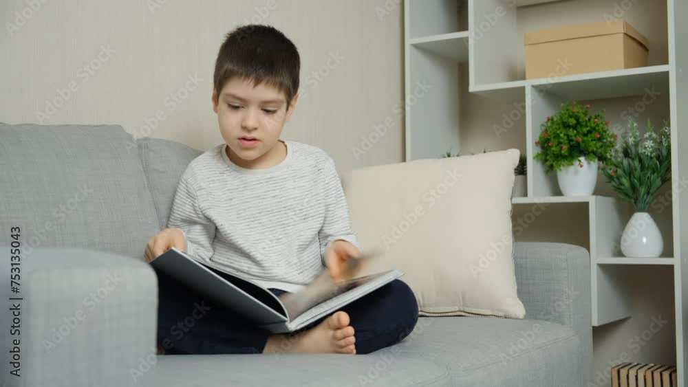 Cute 6 year old child flipping through a book, looking at pictures and learning to read. Cute 6 year old child flipping through a book, looking at pictures and learning to read.