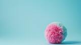 Pink and blue ball made of wool on a pastel blue background. Minimal product promotion. Small business idea.