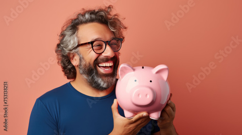 Man smiling broadly, and holding a piggybank, signifying responsible financial planning and savings.