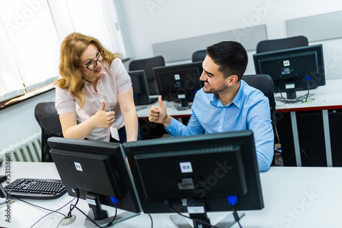 Educator and student in programming school.