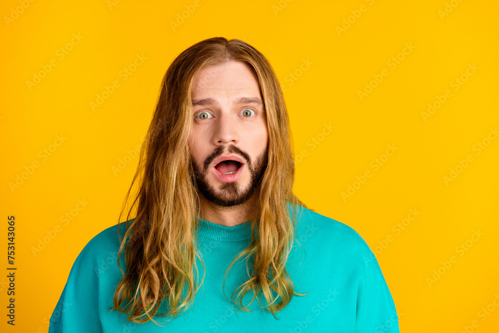 Photo of impressed young man open mouth staring cant believe empty space isolated on yellow color background Photo of impressed young man open mouth staring cant believe empty space isolated on yellow color background