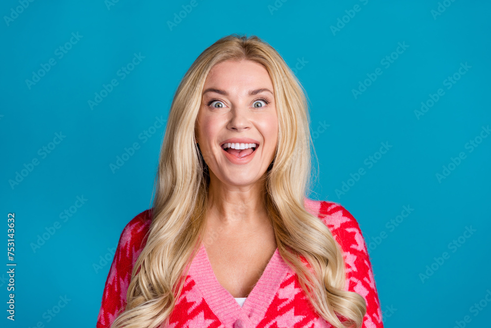 Fototapeta premium Photo of impressed overjoyed woman with wavy hairstyle wear print knit pink cardigan astonished staring isolated on blue color background