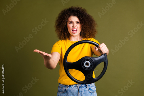 Photo of young woman has conflict in traffict with taxi driver hold steering wheel brand new automobile isolated on khaki color background photo