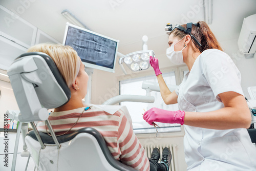 Dentist doctor examination Dental X-rays scan. Dental clinic patient visit modern medical ward. Female sitting in comfortable chair. Health care, medicare industry, heathcare technology concept image photo