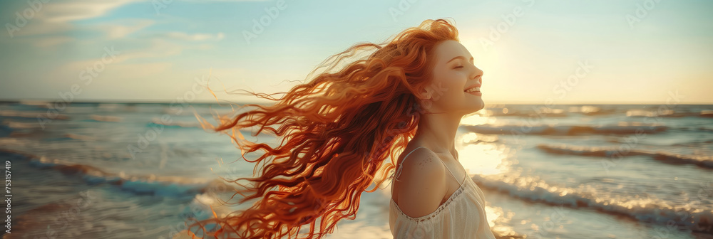 Naklejka premium young pretty woman with long curly red hairs is dancing with the waves of ocean