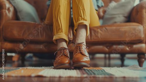 A fashionable young woman kicking back in trendy shoes on a cozy couch, her relaxed posture reflecting her effortless sense of style.