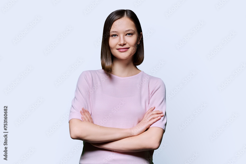 Young confident woman with crossed arms on white background Young confident woman with crossed arms on white background