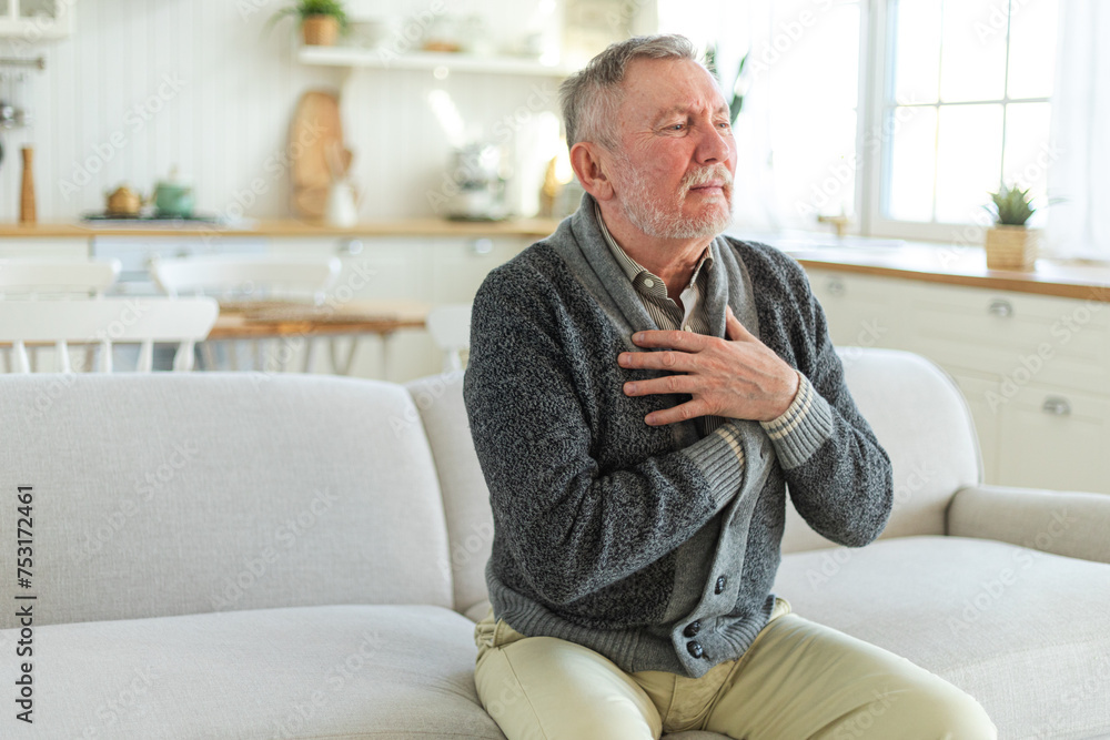 Pain on heart, heart attack. Unhappy middle aged senior man suffering from chest pain heart attack problems with health at home. Mature old senior grandfather touching chest experiencing infarction Pain on heart, heart attack. Unhappy middle aged senior man suffering from chest pain heart attack problems with health at home. Mature old senior grandfather touching chest experiencing infarction