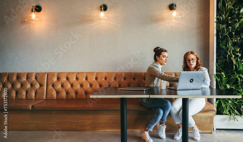 Professional colleagues collaborating on a project in a modern workspace photo