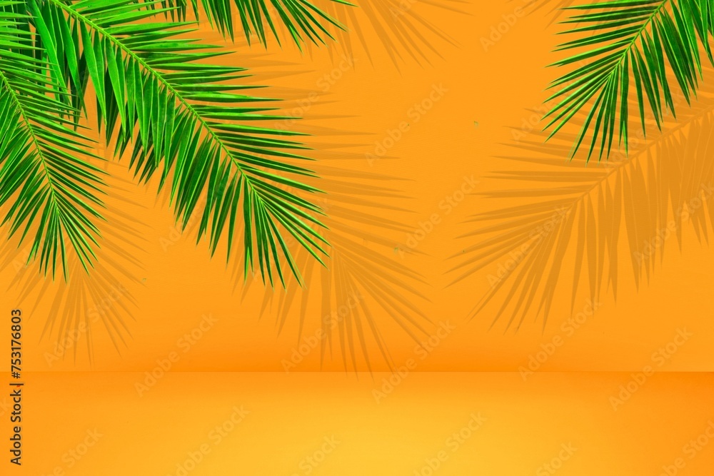 Fototapeta premium Summer concept. Tropical monstera leaf on orange background with copy space 