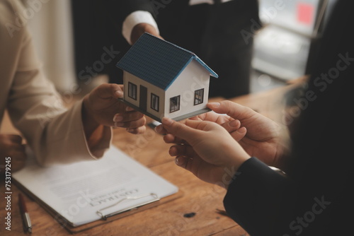 Real estate agent and Sales manager team analysis pricing of rental lease contract of sale purchase agreement, concerning mortgage loan offer for and house insurance.