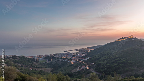 Panorama showing aerial view of Sesimbra Town and Port day to night timelapse  Portugal.