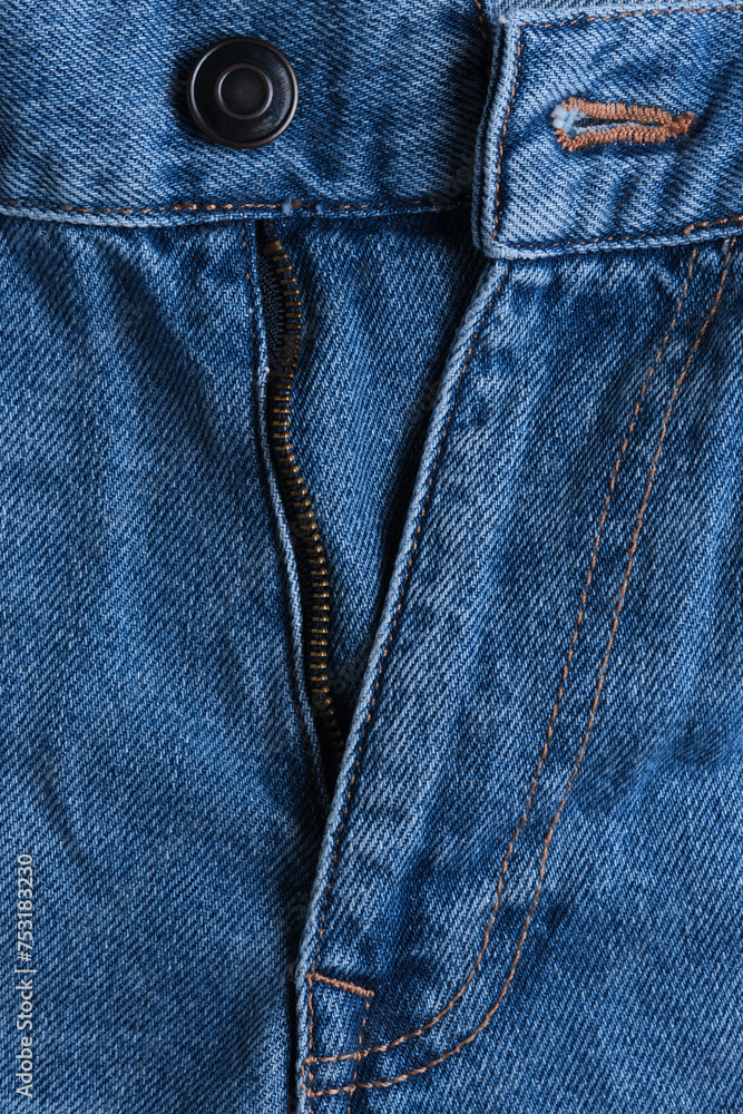 Denim trousers with an unbuttoned fly in closeup.