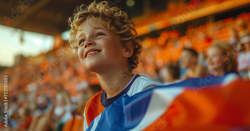 a boy shouting out a flag and sitting in the stands cheer power concept