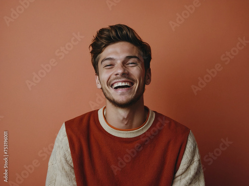 Obraz na płótnie Funny smiling funny young man laughs at the camera, photo studio, Joy Unleashed, The Infectious Laughter of a Dashing Young Man, Maroon background w salonie