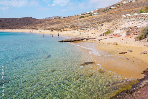 Fototapeta Naklejka Na Ścianę i Meble -  Paralia Agios Sostis wild and free beach in the north of Mykonos, Greece. Pristine bay with blue sea and crystal water, famous for naturism and Kiki's Tavern, peaceful and quiet.