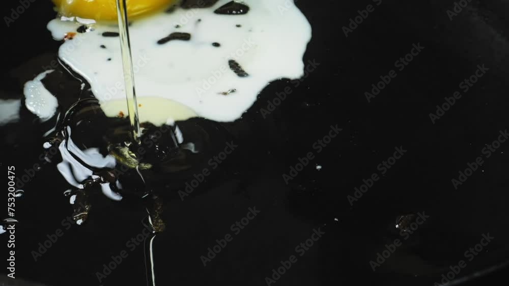 The eggs are broken into a frying pan with heated vegetable oil. Close-up The eggs are broken into a frying pan with heated vegetable oil. Close-up