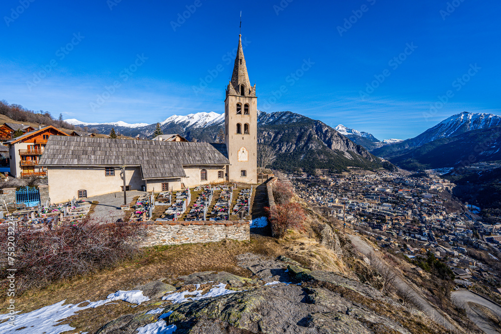 Church of Saint Peter and its graveyard in Puy-Saint-Pierre, a hillside Alpine village located above Briançon in the Hautes Alpes department of the French Alps, France Church of Saint Peter and its graveyard in Puy-Saint-Pierre, a hillside Alpine village located above Briançon in the Hautes Alpes department of the French Alps, France
