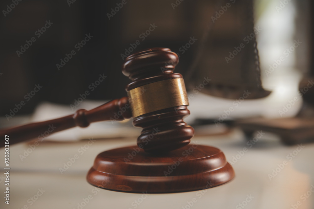 image of judge's hammer, scales lady of justice, law book, laptop computer and contract documents with pen concept of law and justice. image of judge's hammer, scales lady of justice, law book, laptop computer and contract documents with pen concept of law and justice.