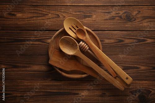 Set of wooden spoons and plate on the table. Kitchen utensils. Flat lay