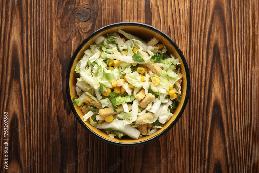 Salad with cabbage and croutons on a wooden background Salad with cabbage and croutons on a wooden background