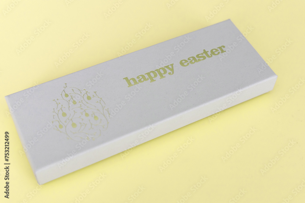 A box of chocolate eggs with the inscription in English Happy Easter. Easter concept. 