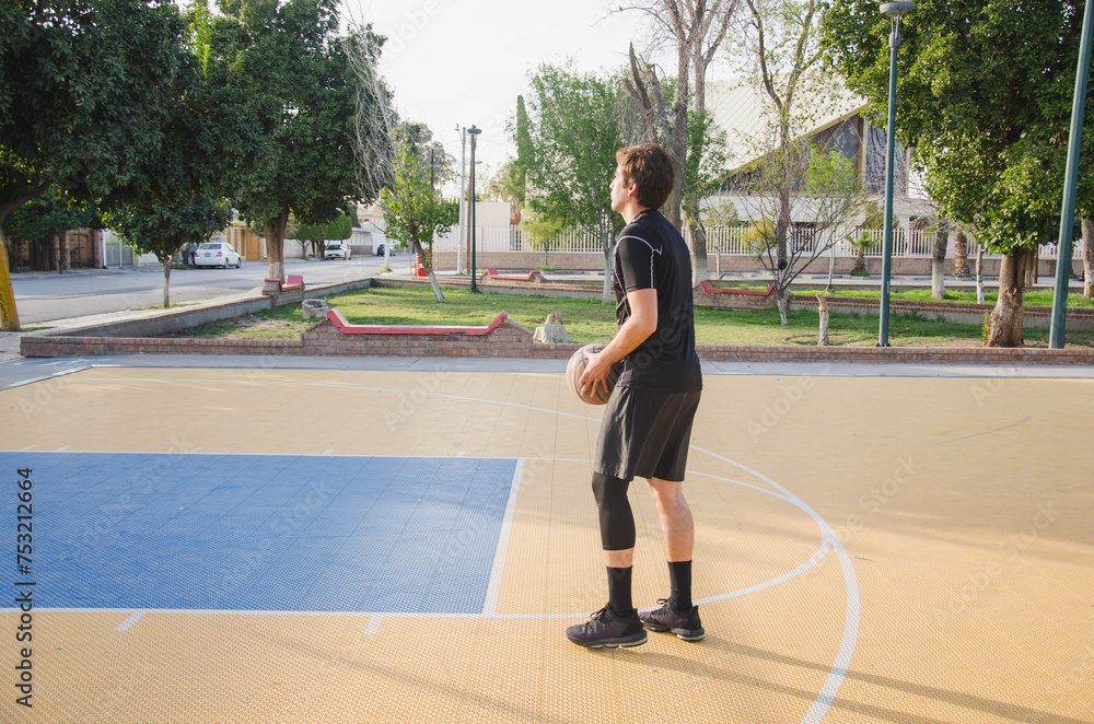 Young Hispanic basketball player in practice session