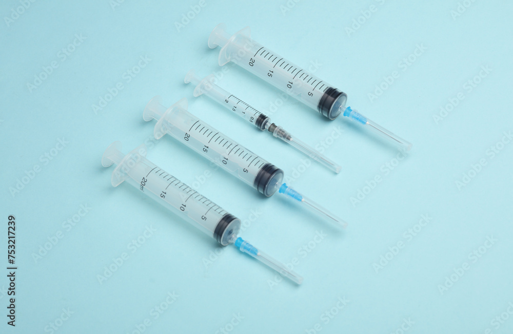 Syringes on a blue background. Medicine concept Syringes on a blue background. Medicine concept