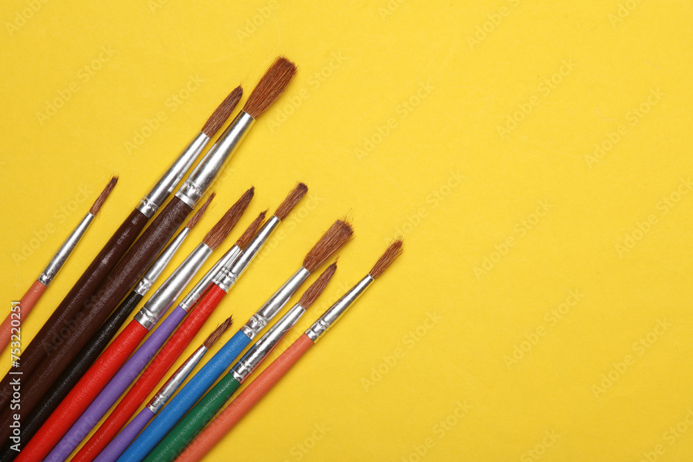 Set of brushes for painting on yellow background Set of brushes for painting on yellow background