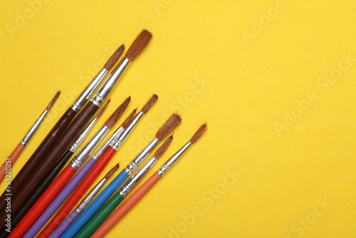 Set of brushes for painting on yellow background