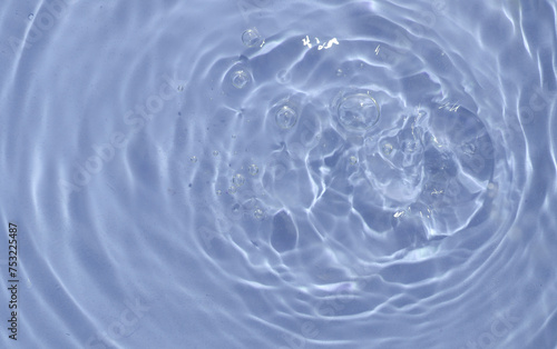 Pink water surface with rings and ripples. Spa concept background.