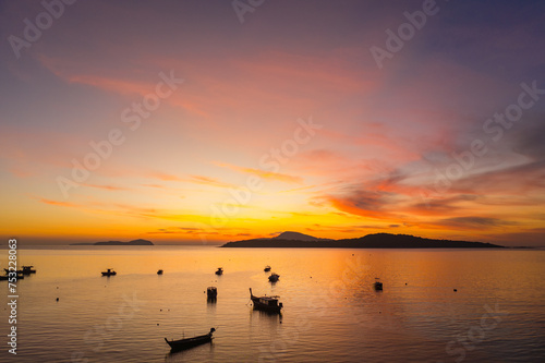 aerial view scenery yellow sky over the island at sunrise..beautiful sky of sunrise at Rawai beach Phuket Thailand.image for travel concept. cloud in sky background..