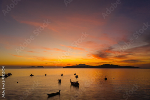 aerial view scenery yellow sky over the island at sunrise..beautiful sky of sunrise at Rawai beach Phuket Thailand.image for travel concept. cloud in sky background..