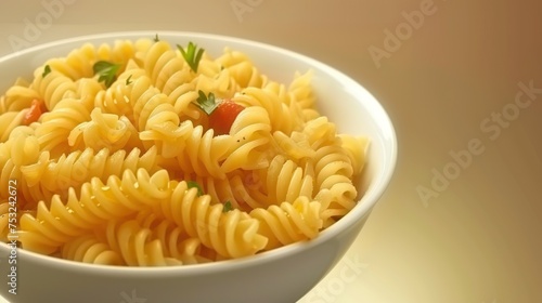 a white bowl filled with pasta and garnished with a green leafy garnish on top of it.