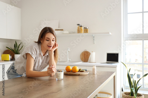 Young woman with tasty yogh...