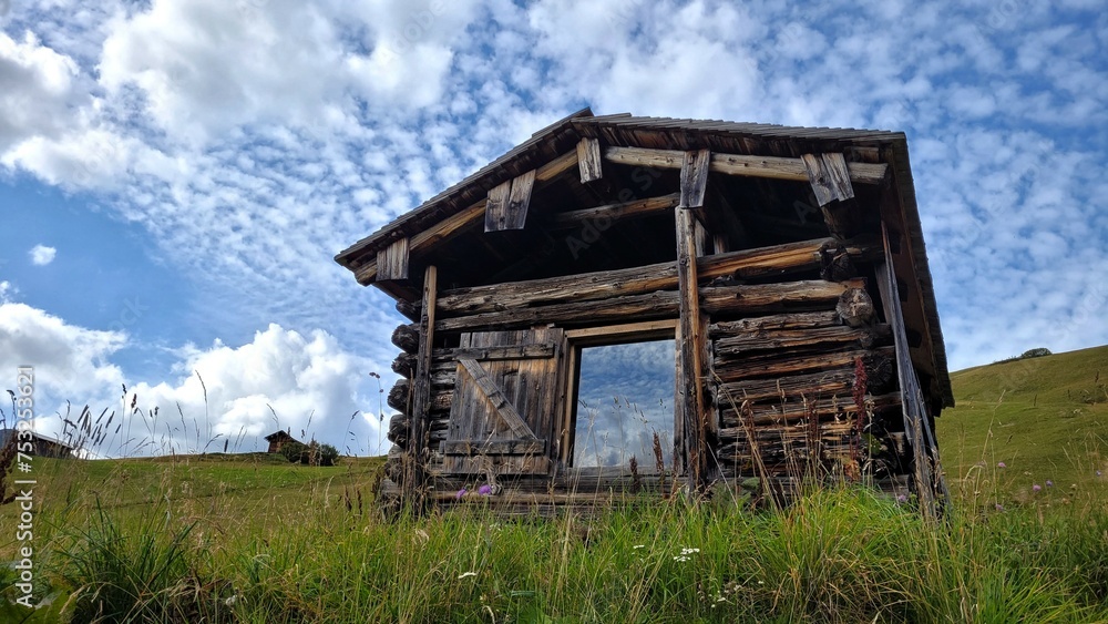 Cute old wooden house in the Alps. Summer landscape Cute old wooden house in the Alps. Summer landscape