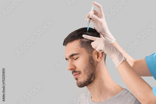 Young man receiving injecti...