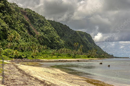 Upolu Island, Samoa, in the Pacific Ocean, Lalomanu Beach overlooking the forested island of Nuutele. Summer, picturesque cumulus clouds in the blue sky, heaven, sun, great vacation and travel.