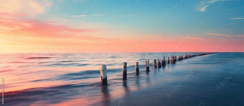 Serenity at Seaside: A Tranquil Scene of a Wooden Pier Extending into the Calm Waters